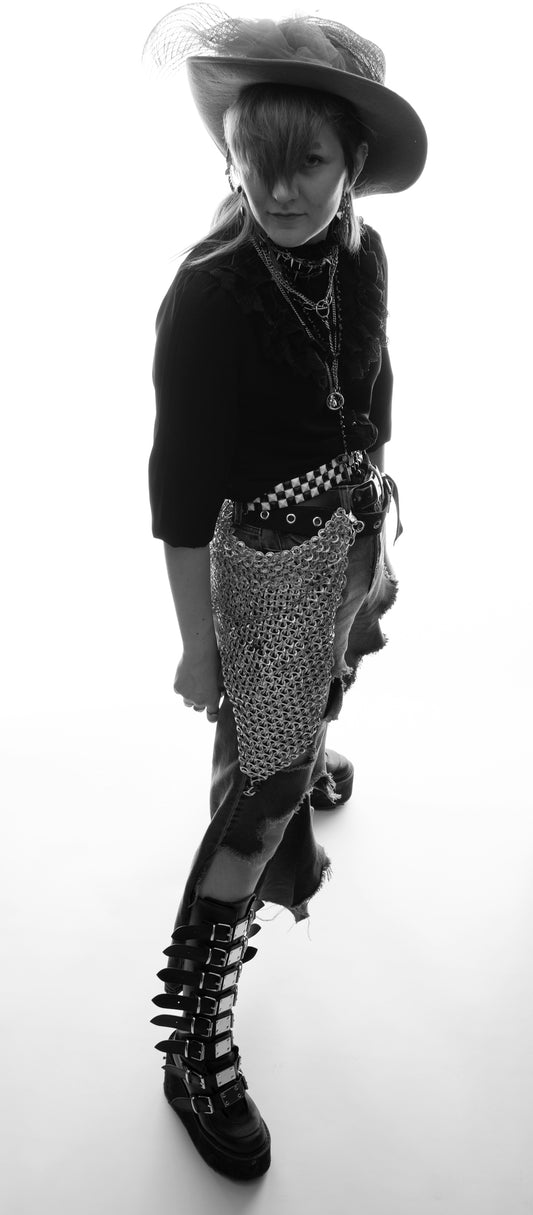 Woman poses in steampunk-inspired attire.